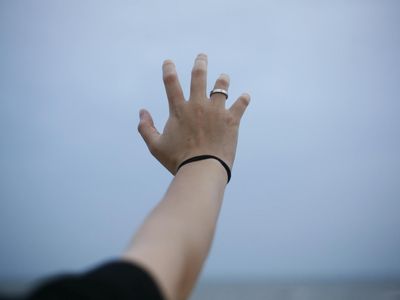 Hands reaching for the sky in a stretching pose.
